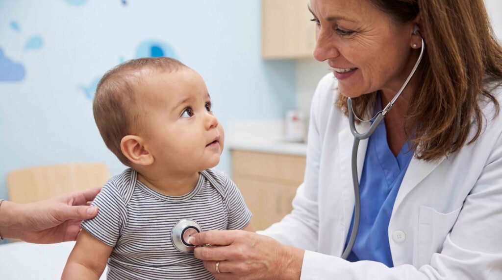 Pediatrician listening to a baby's heartbeat with a stethoscope